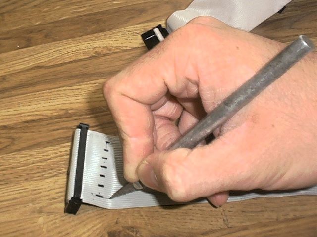 Using an X-acto knife to cut cables