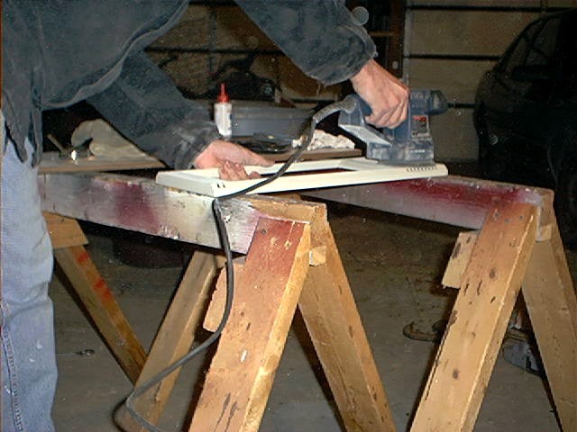 Author sanding parts with a random orbit sander